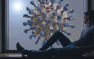 Ung mann i vinduskarmen ser ut på et koronavirus